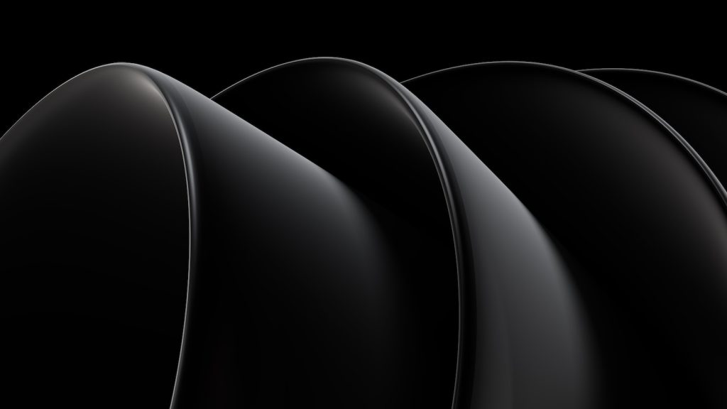 a black background with four curved objects